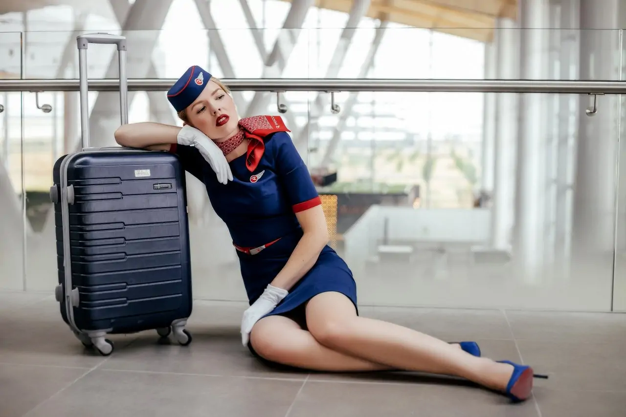 woman sitting on the floor beside black luggage 2754854