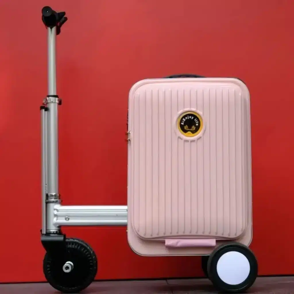 Designer Rideable Electric Luggage Review (20-Inch) 6 Pink 20-inch rideable electric luggage with attached scooter chassis, displayed against a red background.