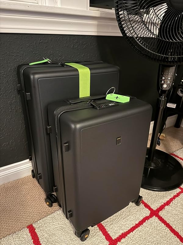 Level8 Textured Luggage Set Review: Durable & Stylish Travel 8 Two Level8 suitcases standing by a wall, decorated with bright green straps and tags.
