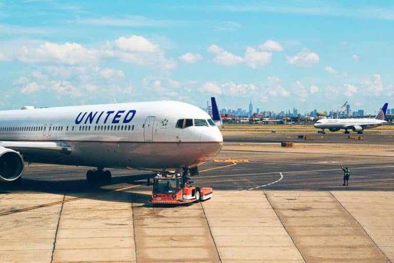 United Airlines aircraft on the runway at a major airport, representing carry-on luggage size rules and overhead bin compatibility.
