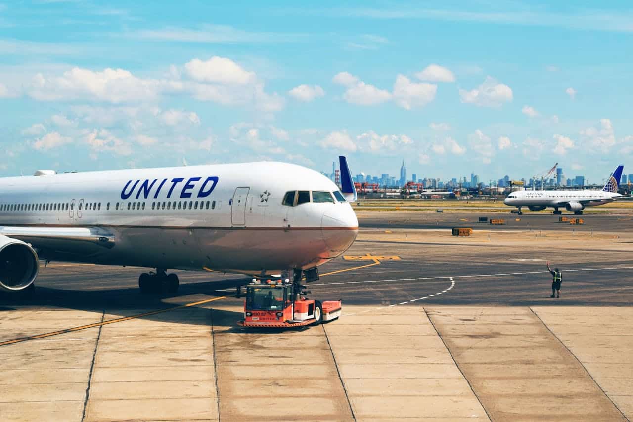 United Airlines aircraft on the runway at a major airport, representing carry-on luggage size rules and overhead bin compatibility.