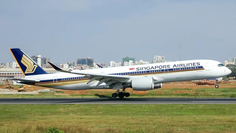 Singapore Airlines aircraft on runway, highlighting international flights and carry-on luggage requirements