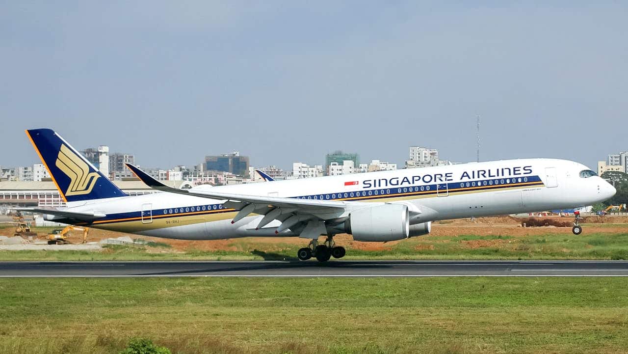 Singapore Airlines aircraft on runway, highlighting international flights and carry-on luggage requirements