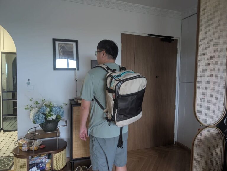Person wearing the Blast Pro 40L travel backpack indoors to demonstrate real-world size and fit