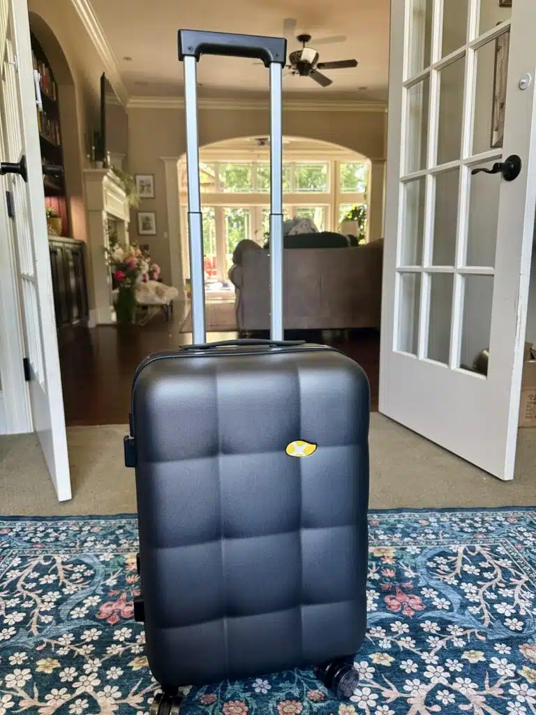 MGB Hardside Carry-On Luggage with telescoping handle extended at home