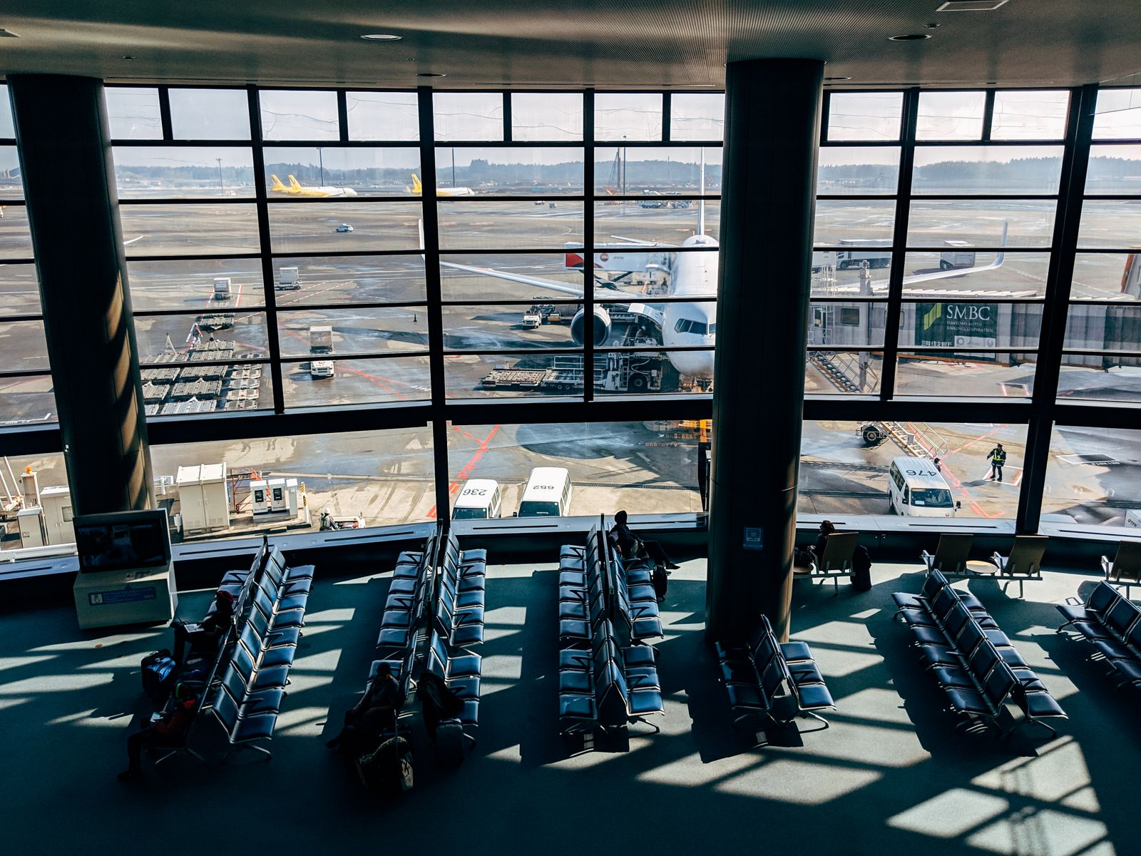 Airport departure gate with aircraft parked outside the terminal windows